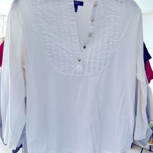 Neat little white shirt with five gold buttons.